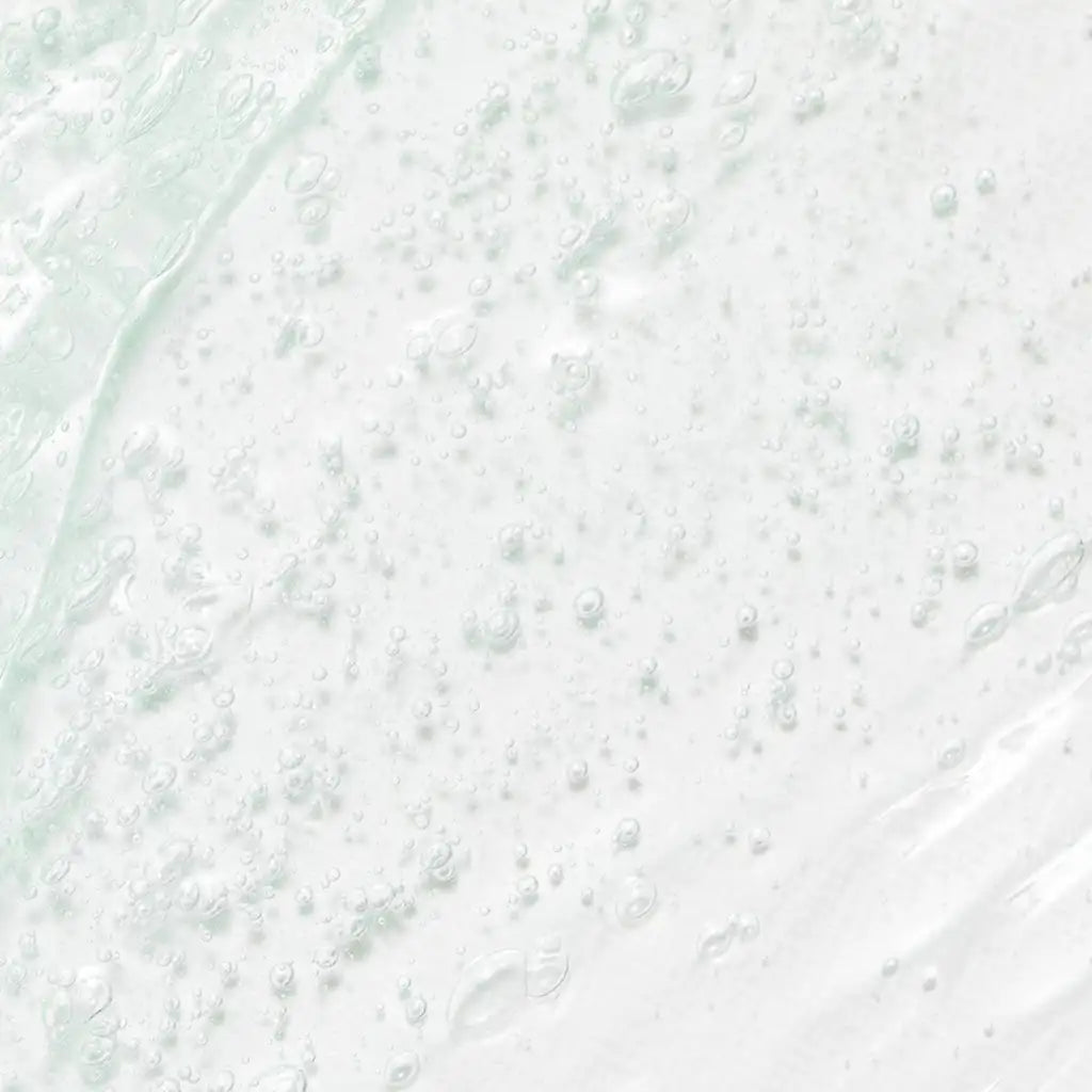 Beauty of Joseon Green Plum Refreshing Cleanser 100ml - A close-up texture shot of a translucent, milky white cosmetic gel or serum with fine bubbles and a soft, glossy sheen -Kbeauty Korean skincare Europe fast delivery - Skincare coréenne SKINOREA shop Paris France livraison rapide 